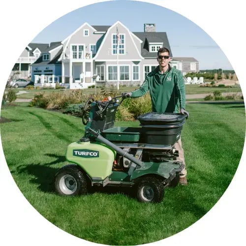 Lawn care specialist from Mainely Grass with turf care equipment